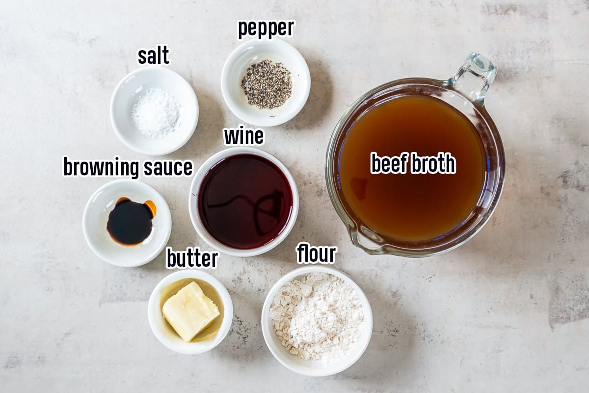 Beef broth in a measuring cup surrounded by wine, butter, and seasoning in small bowls with text.