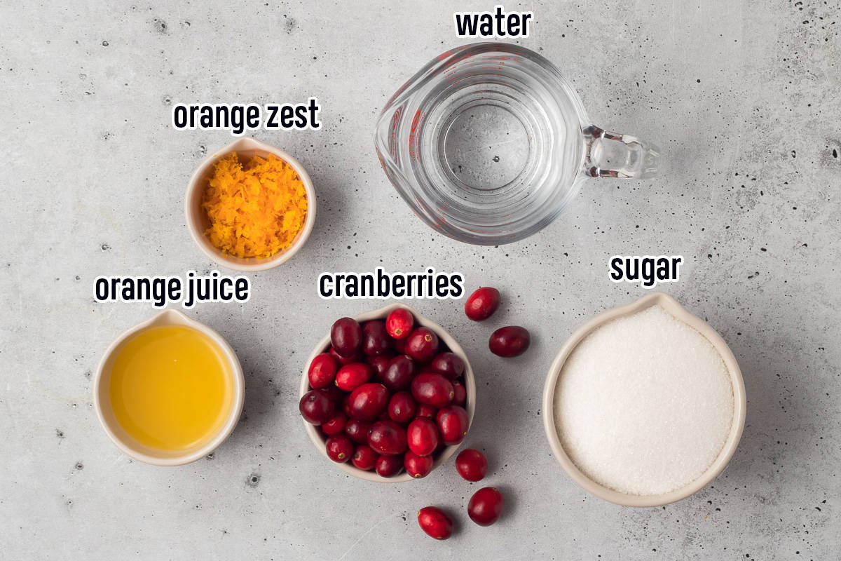 Fresh cranberries, water, sugar, orange zest, orange juice in bowls with text.