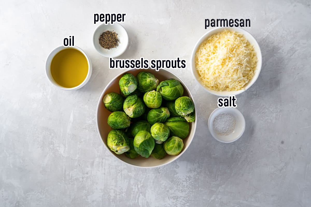 Brussels sprouts, oil, Parmesan cheese, salt and pepper in bowls with text.