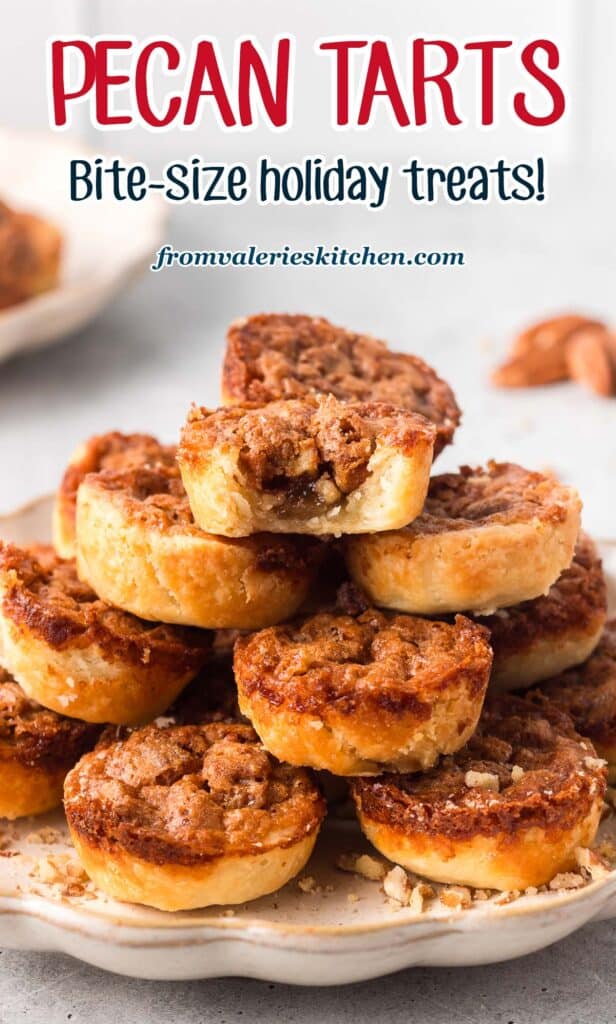 Pecan tarts piled on a plate with a bite missing from the one on top with text.