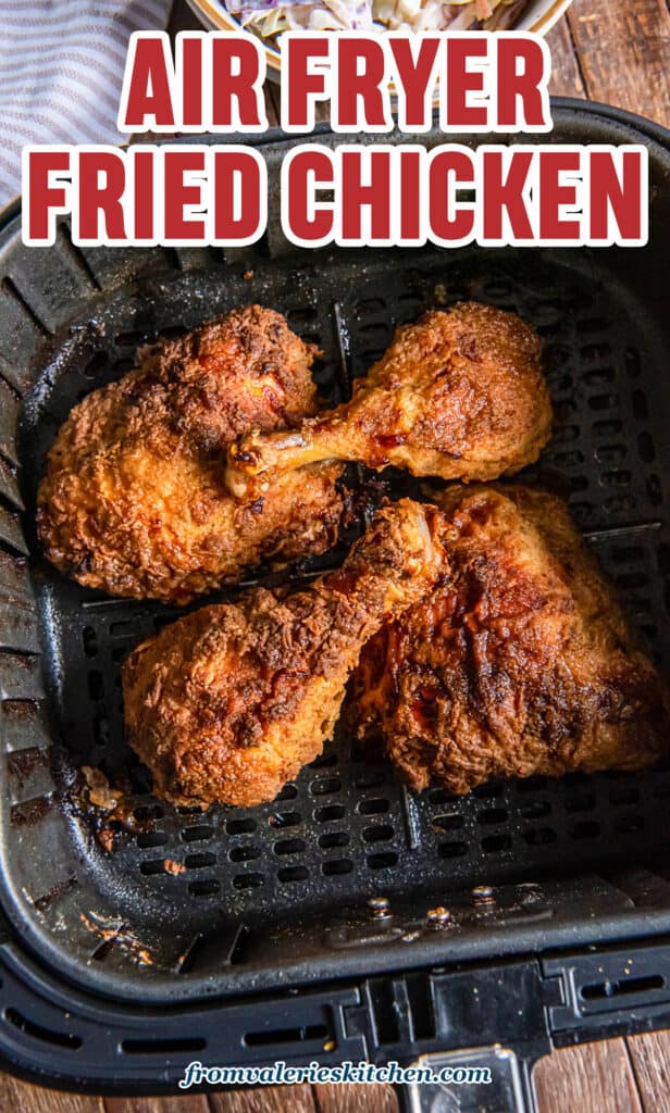 A top down shot of air fried chicken in an air fryer basket with text.