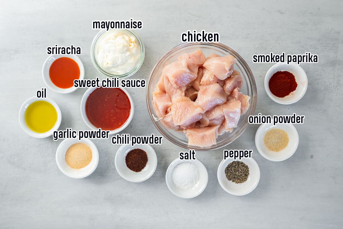 Chunks of chicken, sweet chili sauce, mayonnaise and other ingredients in small bowls with text.