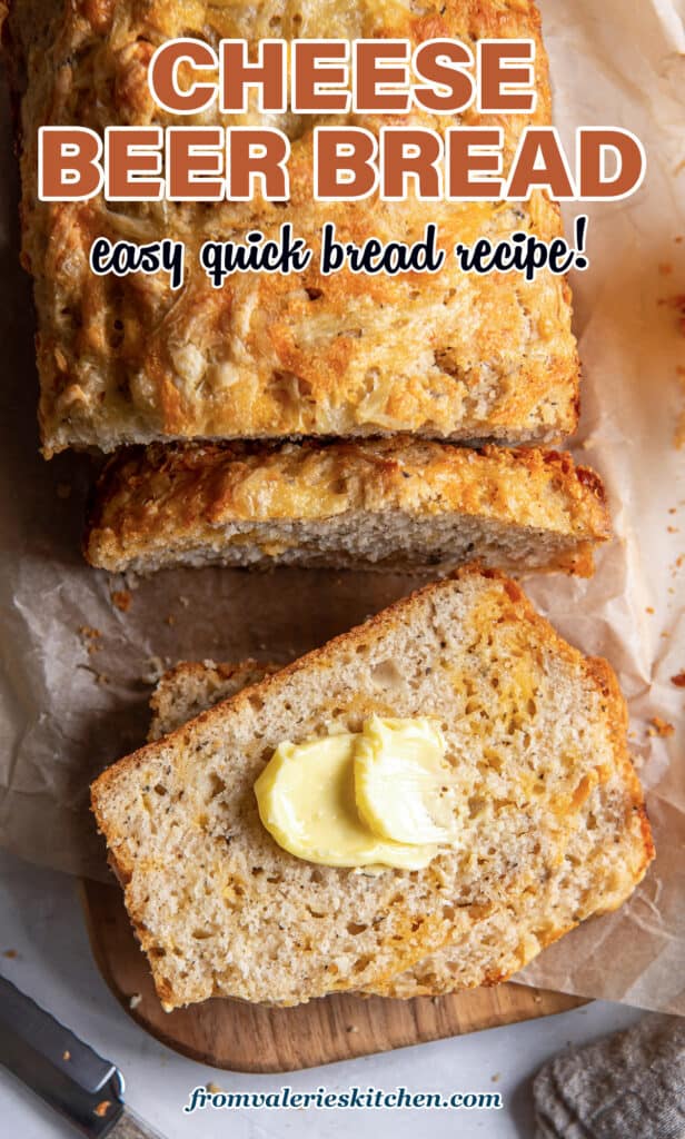 A top down shot of a buttered sliced of cheese beer bread with text.