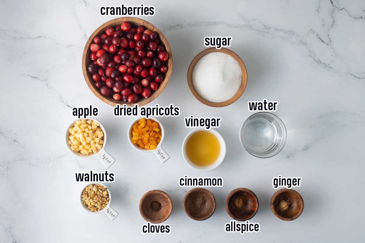 Fresh cranberries, diced apple, dried apricots and other ingredients in small bowls with text.