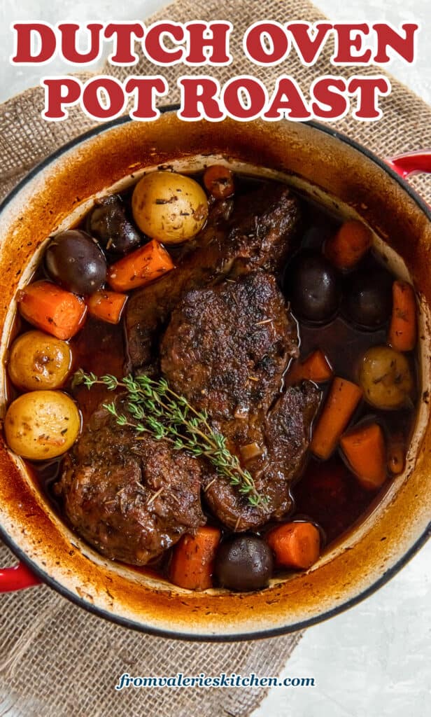 A top down shot of a pot roast with vegetables in a Dutch oven with text.