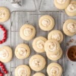 Eggnog thumbprint cookies on a wire rack.