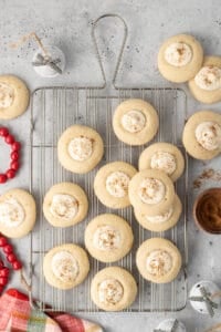 Eggnog thumbprint cookies on a wire rack.