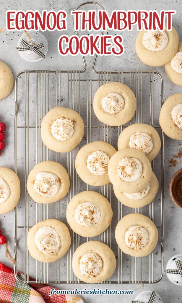 Eggnog thumbprint cookies on a wire rack with text.