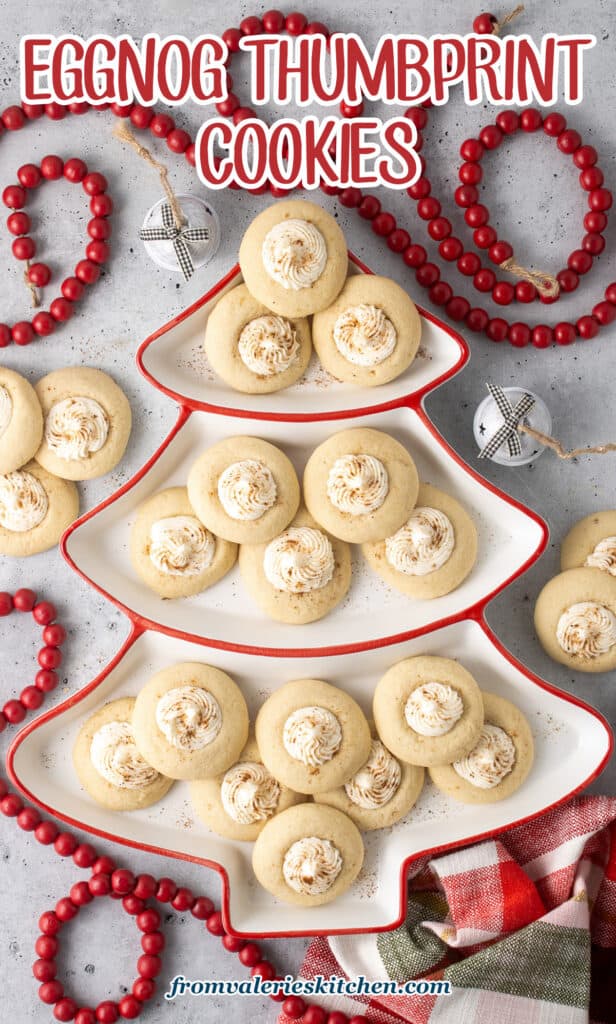 Eggnog thumbprint cooikies on a platter shaped like a Christmas tree.