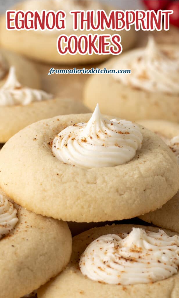 A close up of an eggnog thumbprint cookie dusted with nutmeg with text,