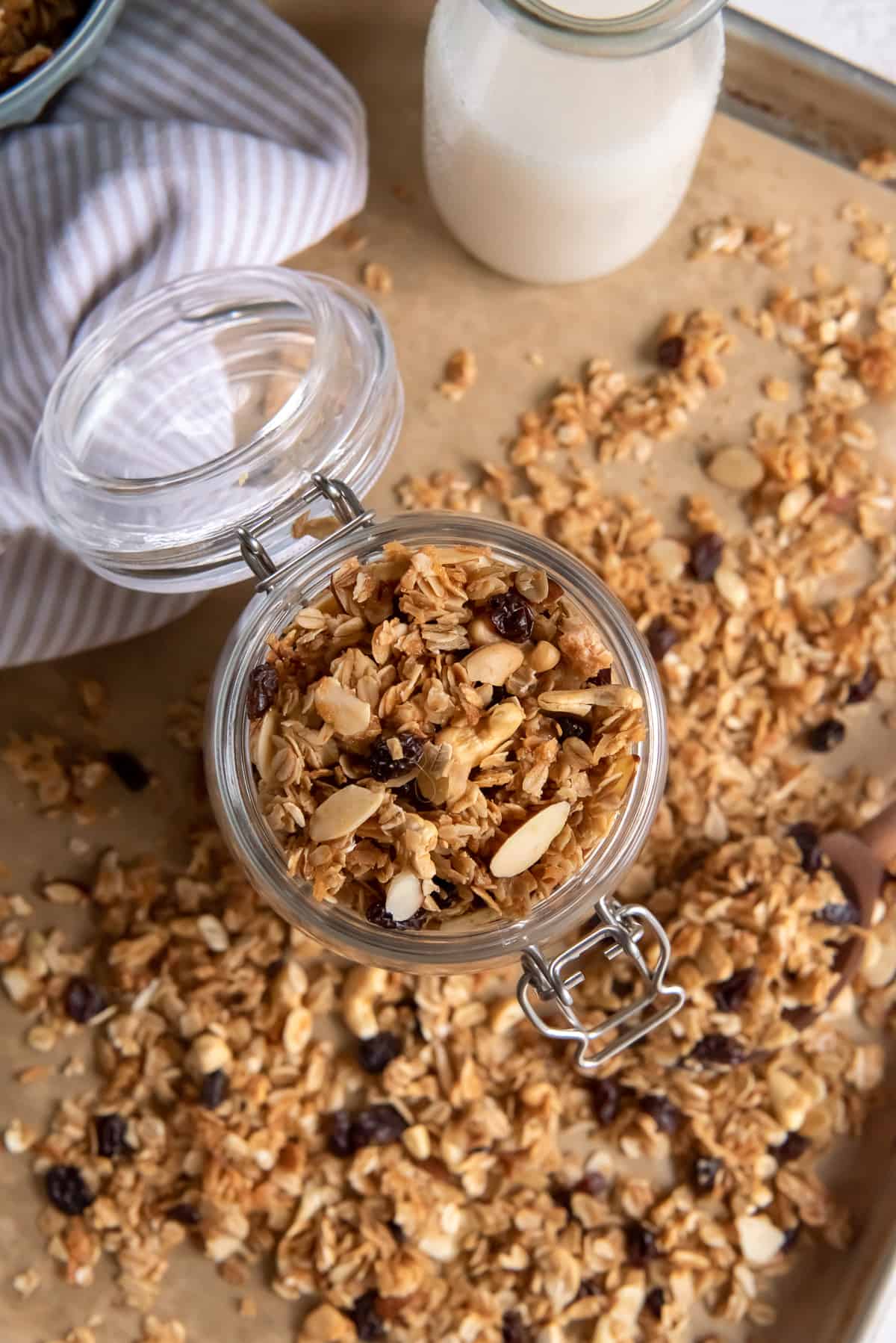 A top down shot of maple honey granola in a glass jar.