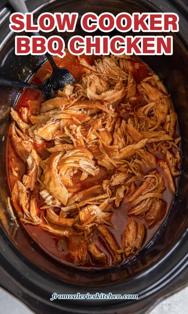 A top down shot of shredded BBQ chicken in a slow cooker with text.