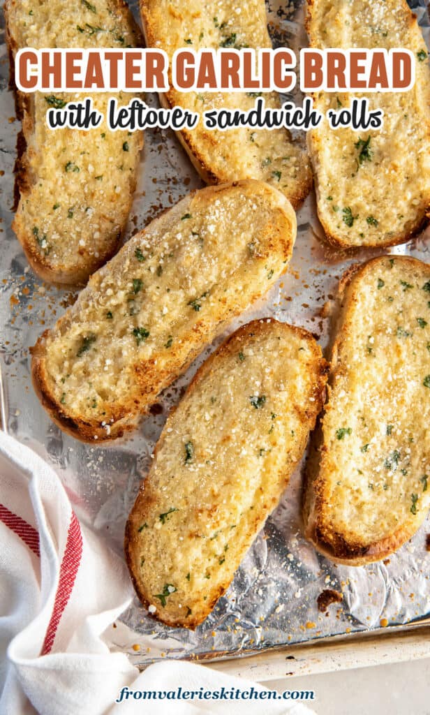 A top down shot of garlic bread made with hoagie rolls on a baking sheet with text.