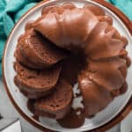 A top down shot of a sliced black russian bundt cake on a white platter.