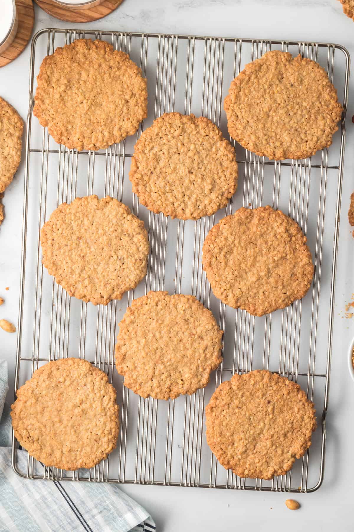 Crispy peanut cookies cooling on a wire rack.
