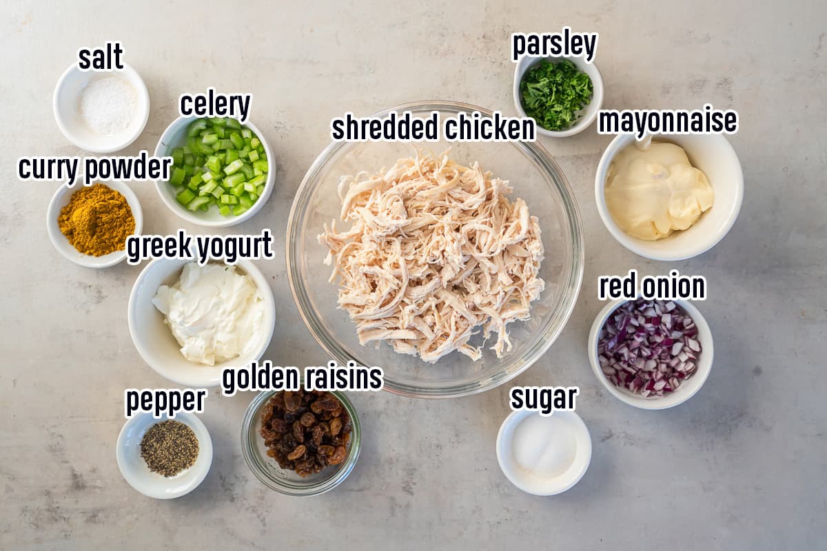 Shredded rotisserie chicken, curry powder, mayonnaise, Greek yogurt and other ingredients in bowls with text.