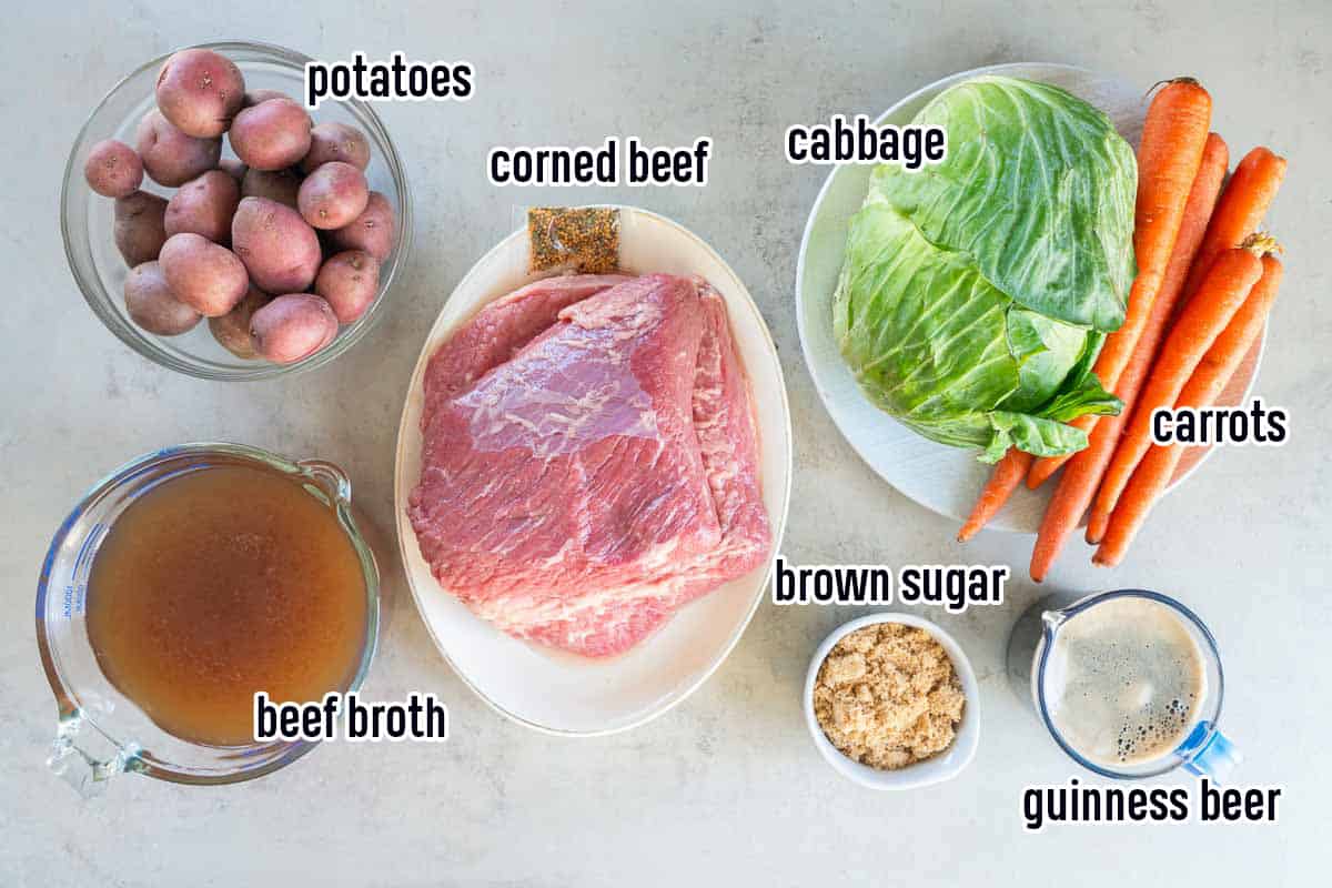 Corned beef, cabbage, carrots, potatoes, Guinness beer and other ingredients in bowls with text.