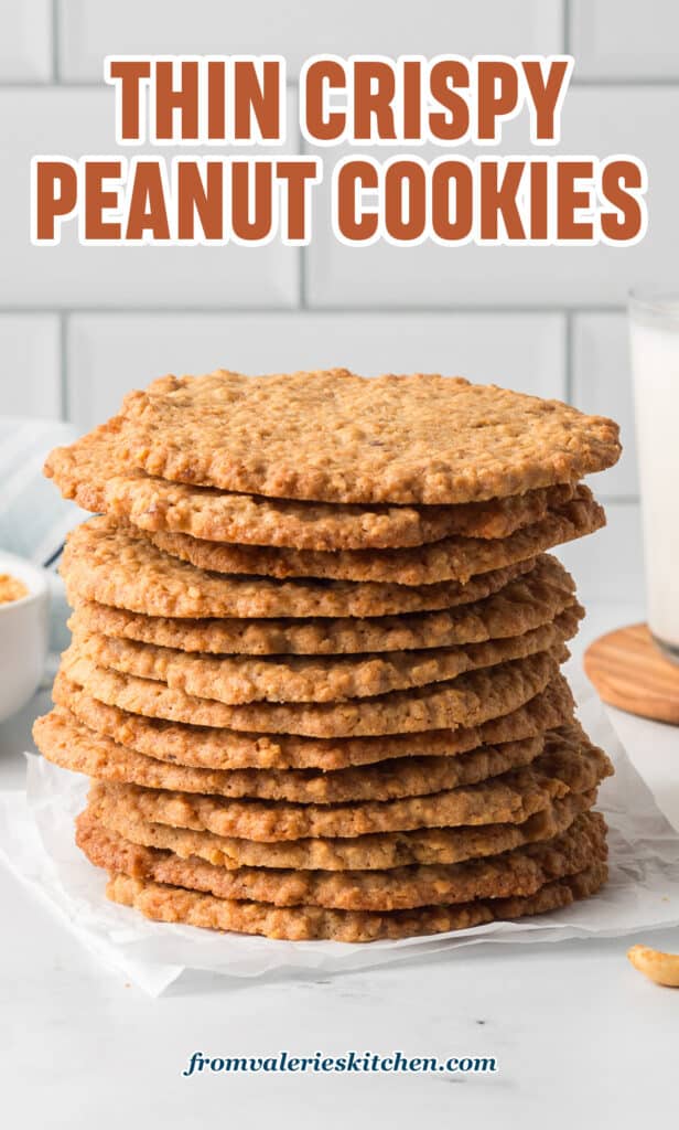 A stack of thin crispy peanut cookies on a kitchen counter with text