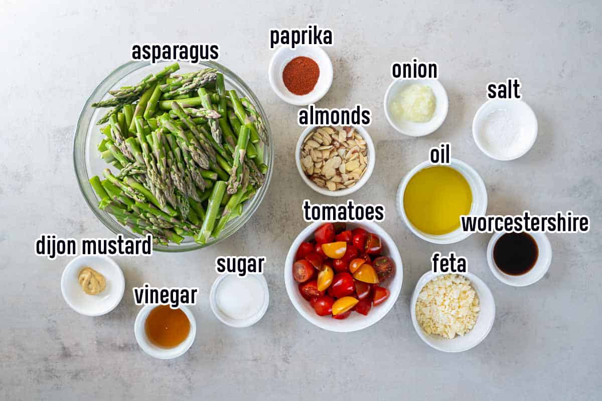 Asparagus spears, cherry tomatoes and other ingredients in bowls with text.