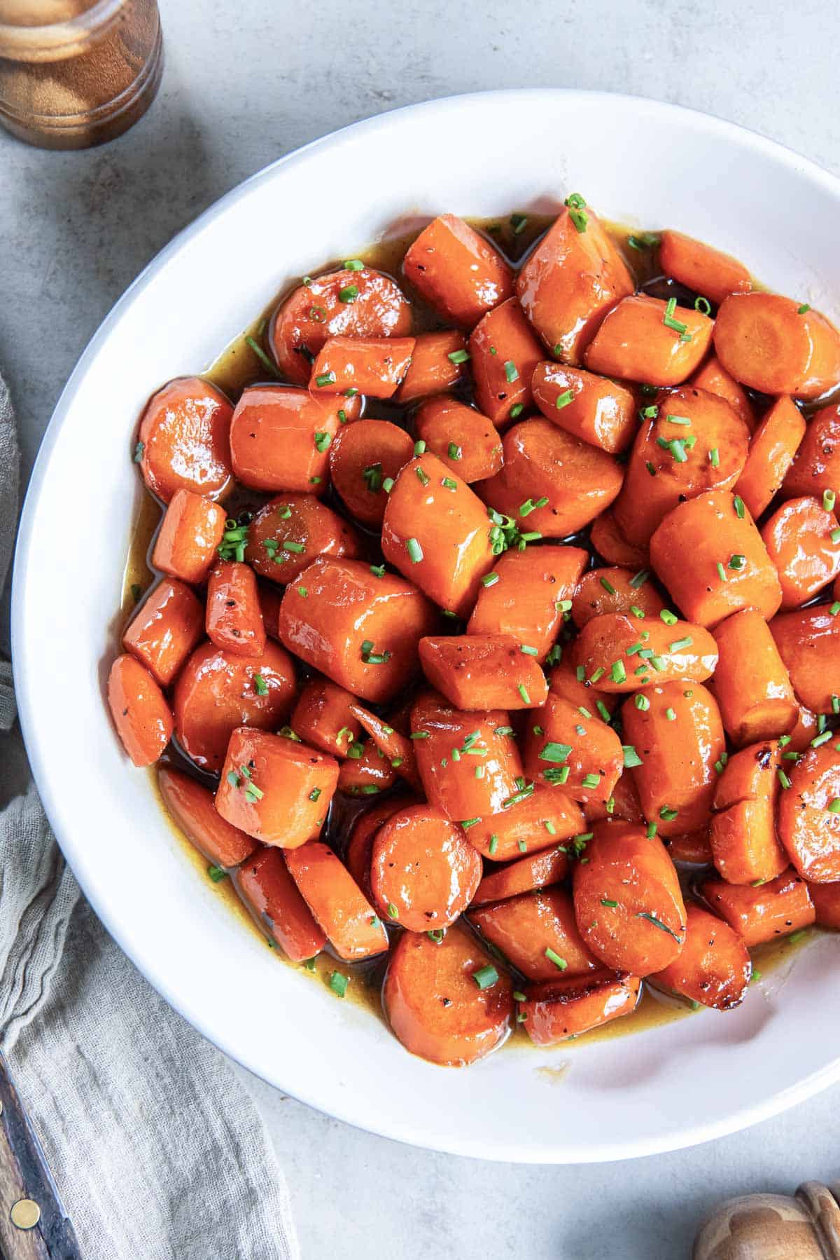 Bourbon glazed carrots in a white serving bowl.