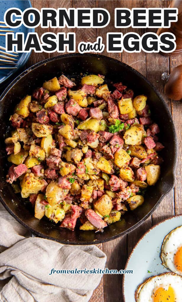 Corned beef hash in a cast iron skillet next to a plate of fried eggs with text