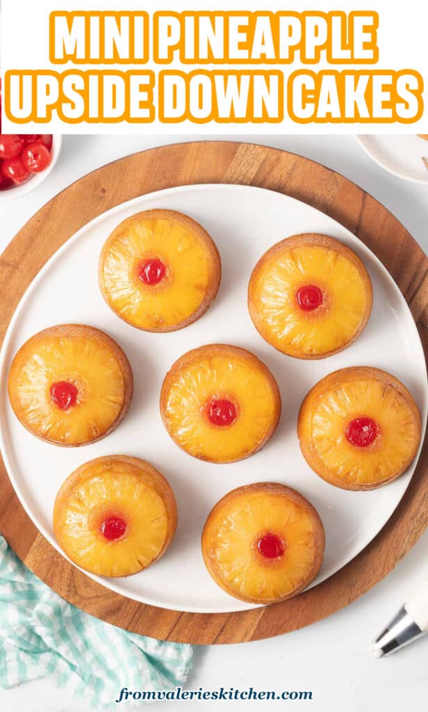 Mini pineapple upside down cakes on a white plate with text.