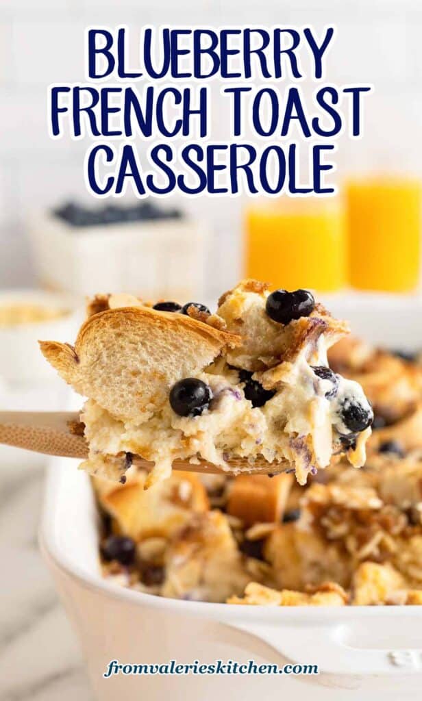 A wooden spoon scooping blueberry French toast casserole from a baking dish with text.