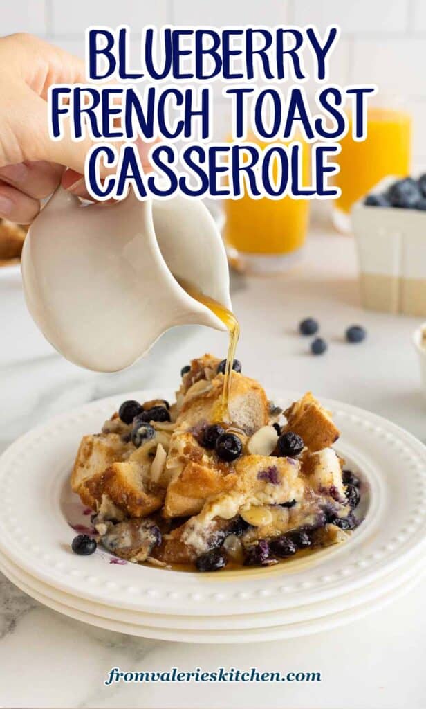 Maple syrup pouring on to a serving of blueberry French toast casserole with text.