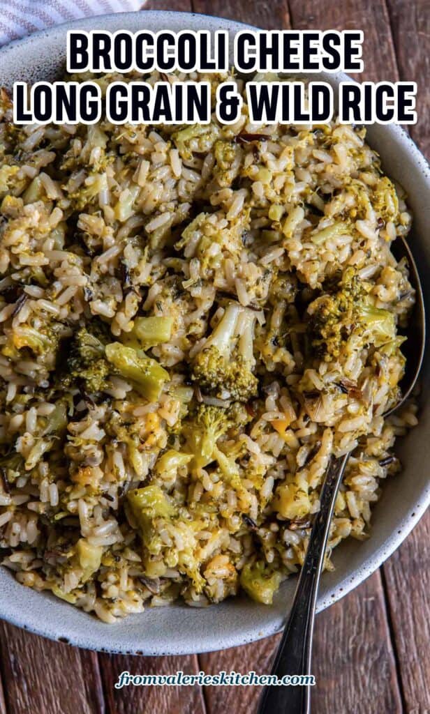 A serving spoon resting in a bowl of broccoli cheese rice with text.