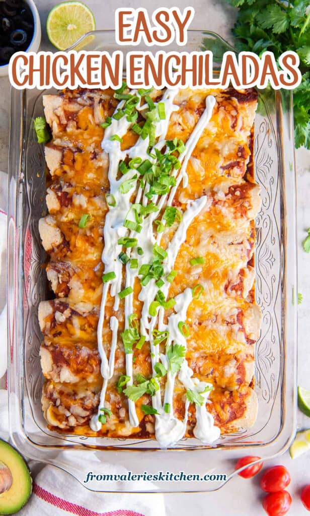 Chicken enchiladas in a baking dish topped with sour cream and sliced green onions with text.