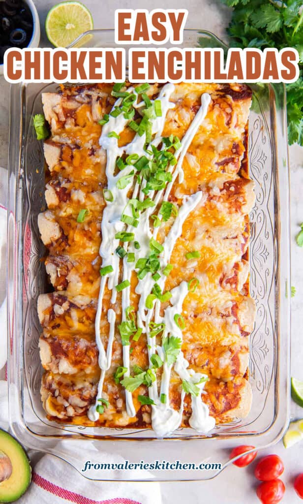 Chicken enchiladas in a baking dish topped with sour cream and sliced green onions with text.