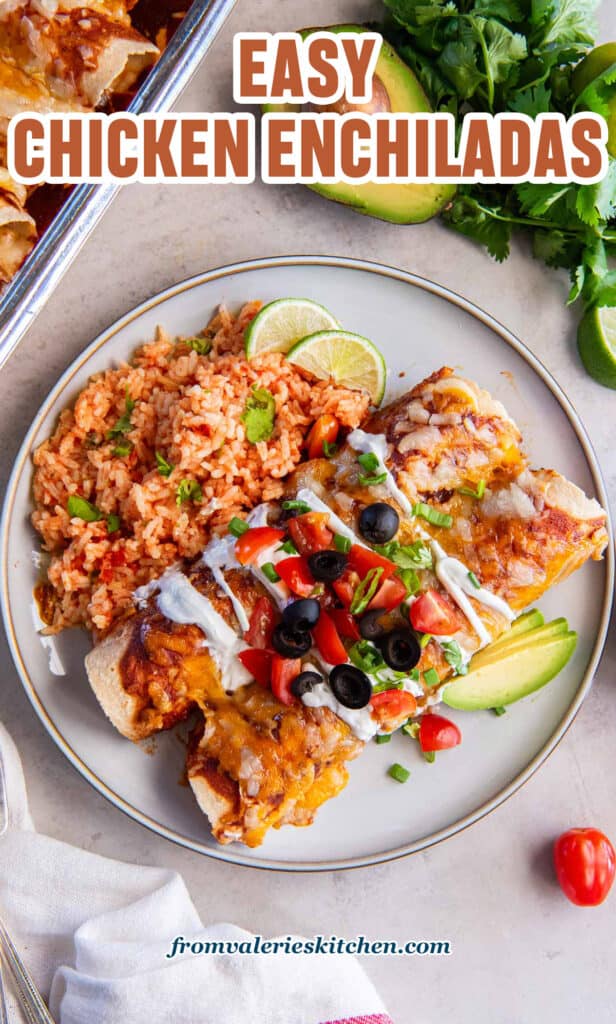 Two chicken enchiladas on a dinner plate with mexican rice with text.
