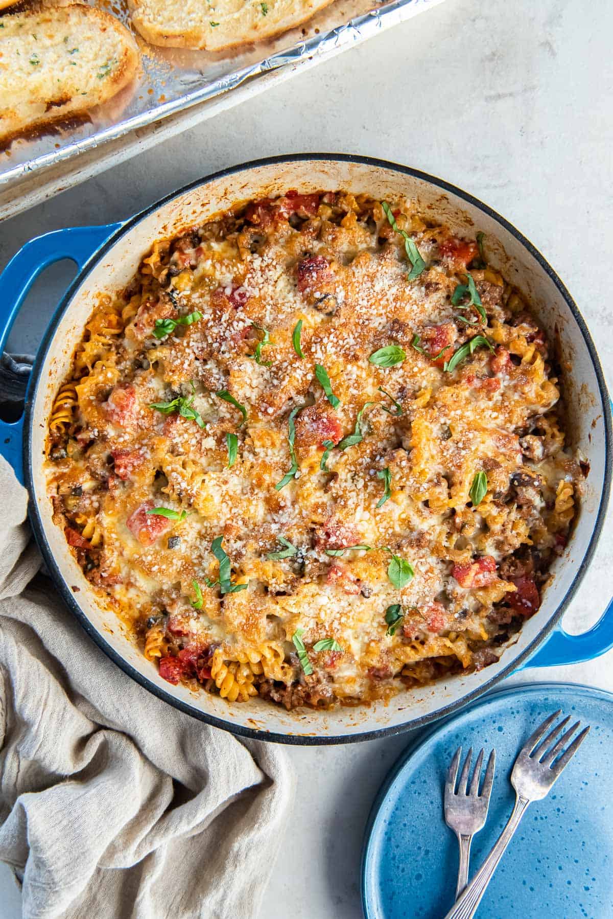 Ground beef pasta topped with melted cheese in a skillet.