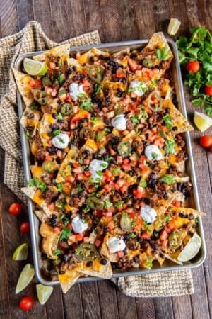 Nachos with ground beef on a baking sheet.