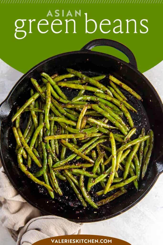 Asian green beans in a cast iron skillet with overlay text.