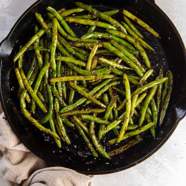 Stir fried Asian green beans in a cast iron skillet.