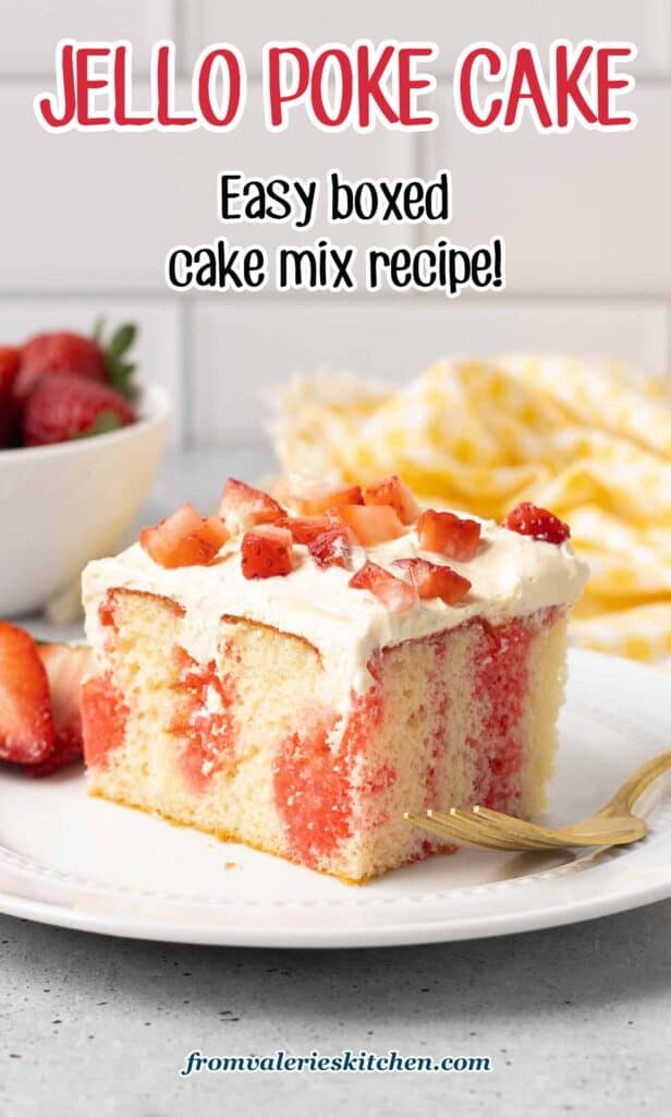 A fork resting on a plate with a slice of jello cake topped with strawberries with text.
