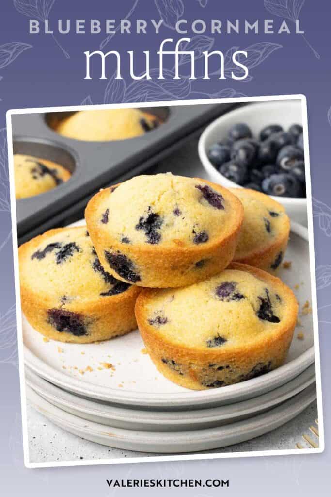 Blueberry cornmeal muffins stacked on a stack of white plates with text overlay.