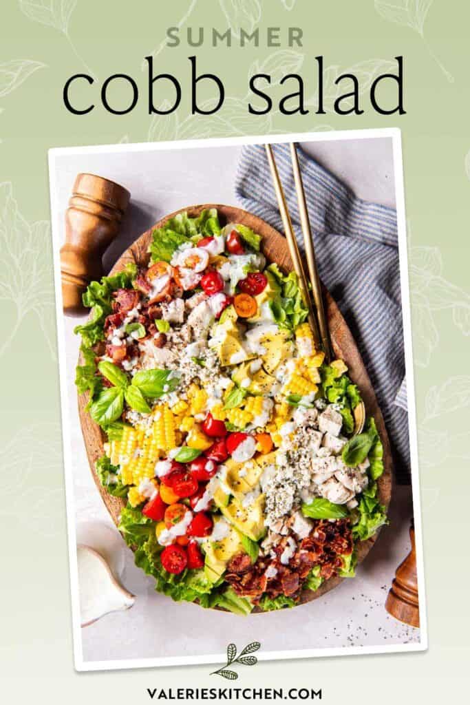 Summer cobb salad topped with basil buttermilk ranch in a wood bowl with text.