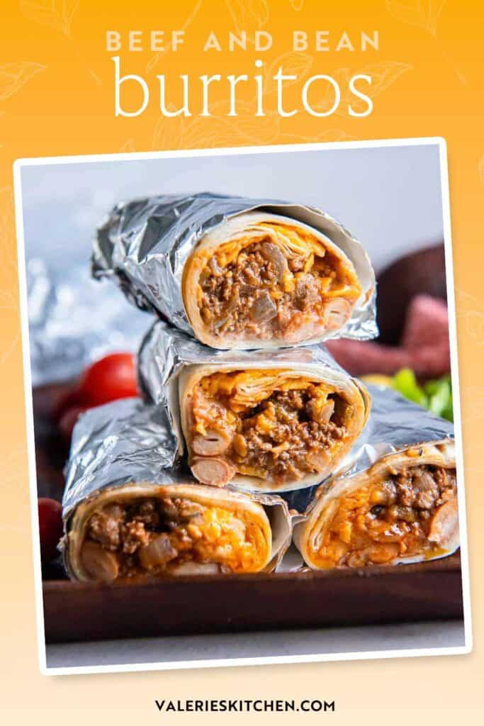 Foil wrapped beef and bean burritos sliced in half and stacked on a cutting board with text.