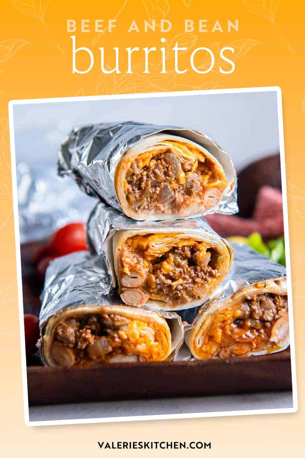 Foil wrapped beef and bean burritos sliced in half and stacked on a cutting board with text.