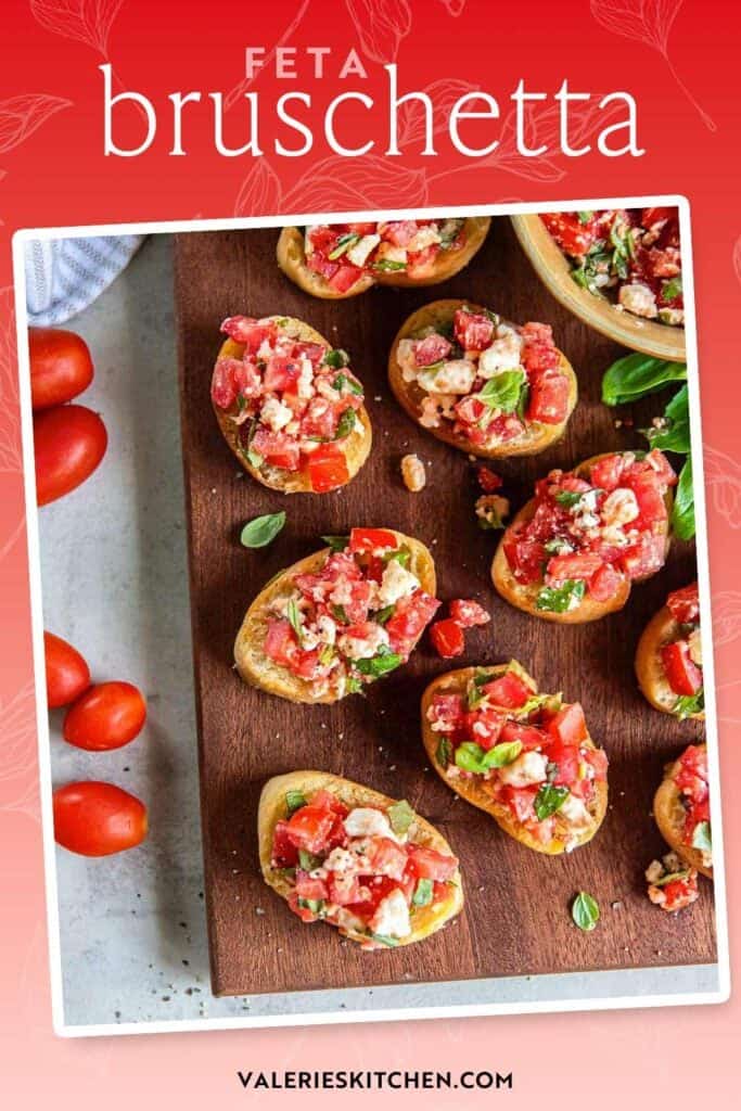 Sliced baguette topped with feta bruschetta on a brown board with a bowl full of bruschetta mixture with text.