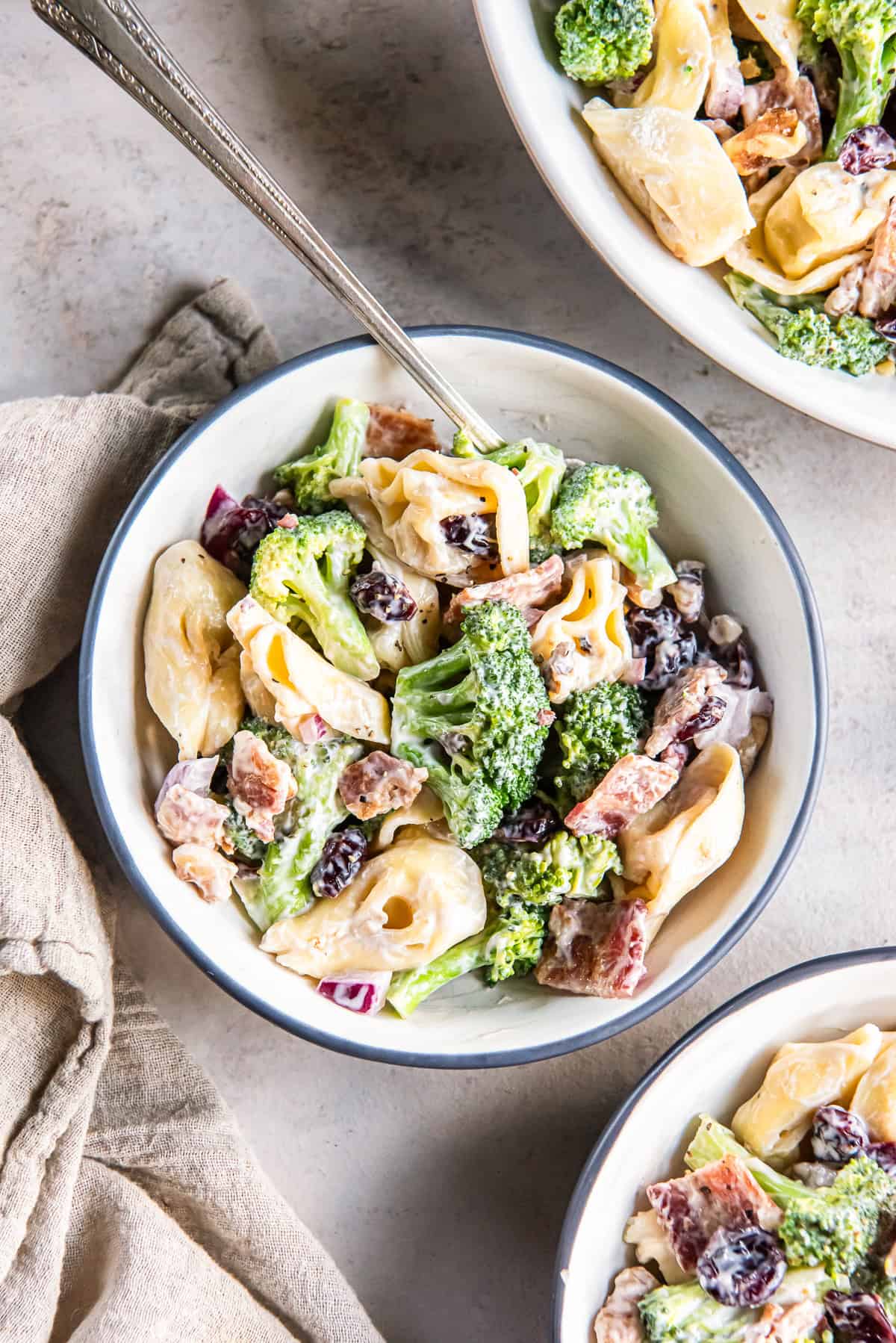 Small bowls of tortellini broccoli salad.