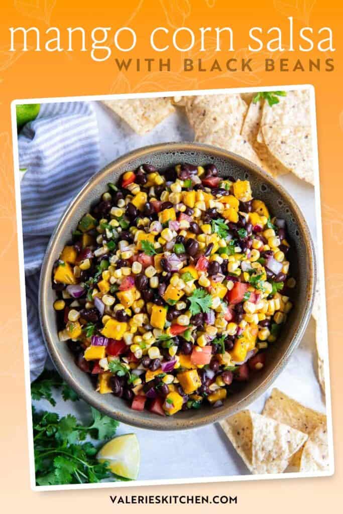 Mango corn salsa with black beans in a large serving bowl surrounded by tortilla chips with text overlay.