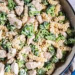 Chicken broccoli alfredo in a blue skillet.