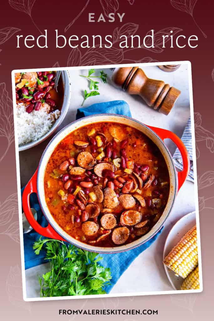 Red beans with sausage in a Dutch oven next to a pepper shaker and corn on the cob with text overlay.