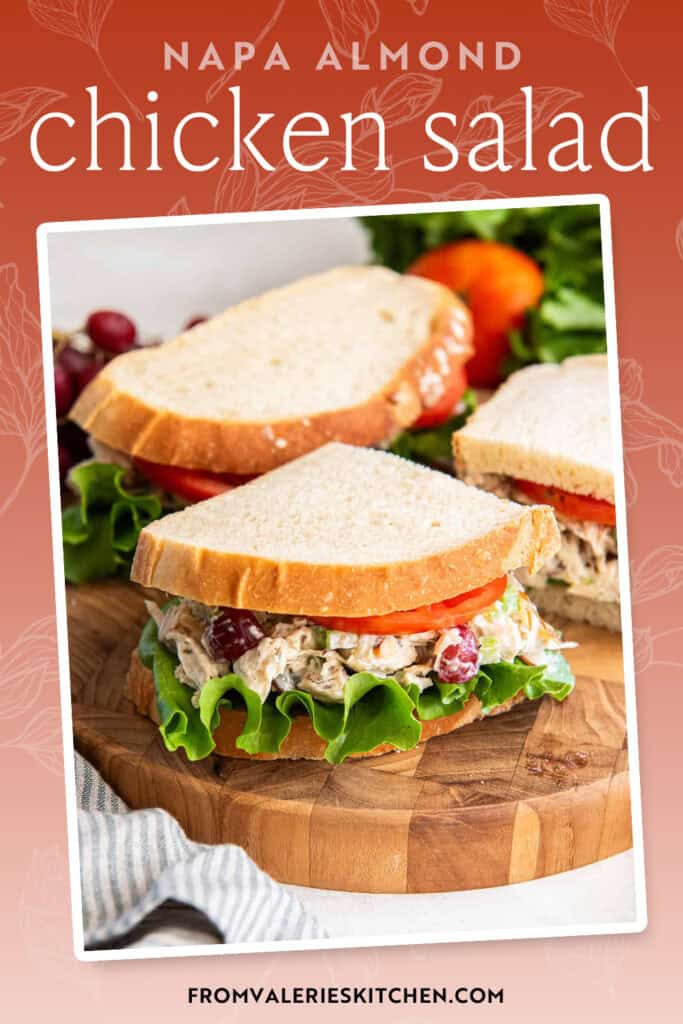 A copycat Panera chicken salad sandwich sliced and resting on a cutting board with text overlay.