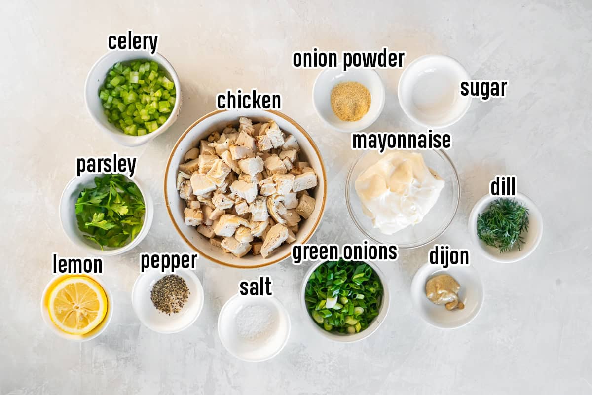 Chopped rotisserie chicken, mayonnaise, celery, and other ingredients in bowls with text overlay.