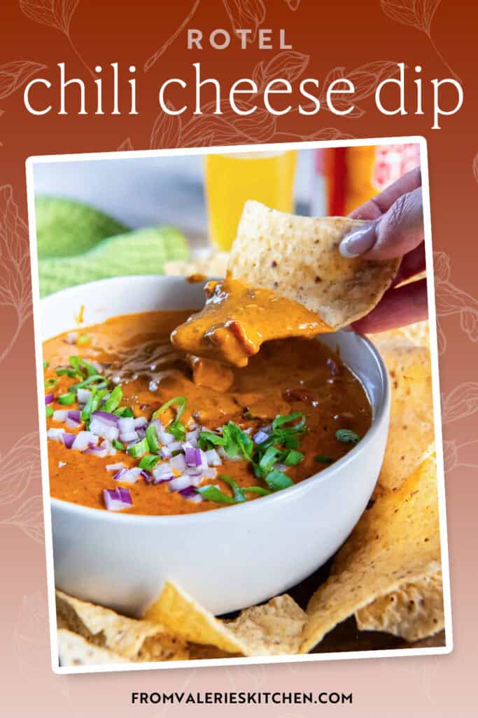 A hand dipping a tortilla chip into a bowl of chili cheese dip with text overlay.