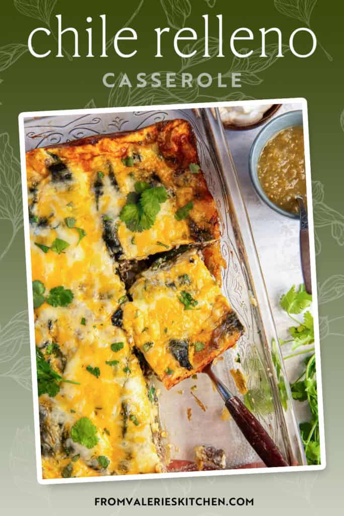 A spatula resting under a slice of chile relleno casserole in a baking dish with text overlay.